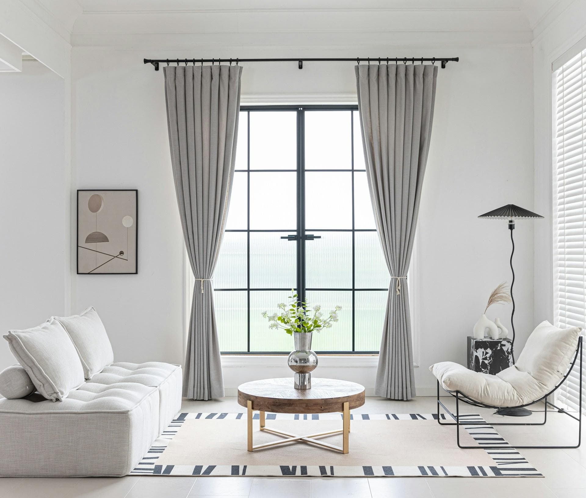 Modern living room with custom pinch-pleat drapery and rod hardware